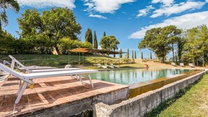 A swimming pool with lounge chairs and a pergola. - Holiday Home in Celle Sul Rigo With Swimming Pool (San Casciano dei Bagni)
