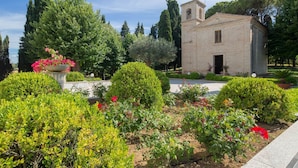 Un petit bâtiment en briques, doté d’un clocher, entouré de jardins et d’arbres bien entretenus.