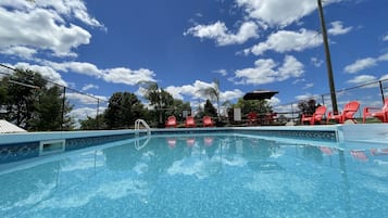 Seasonal outdoor pool, open 10:00 AM to 8:00 PM, pool umbrellas