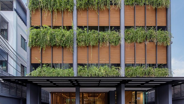 A modern building with multiple balconies, each with vertical gardens. - GROOVE AT SIAM (Bangkok)