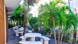 A courtyard with outdoor seating and palm trees.