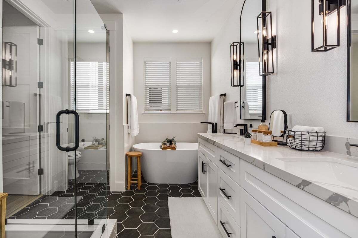 Master bathroom with walk in closet, bathtub, large walk in shower and toilet. 