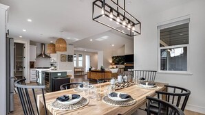 A modern kitchen with a dining area.