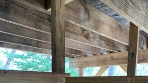 A wooden interior with exposed beams and a view of trees outside. - Private Lakefront with Dock! (MONGAUP VALLEY)