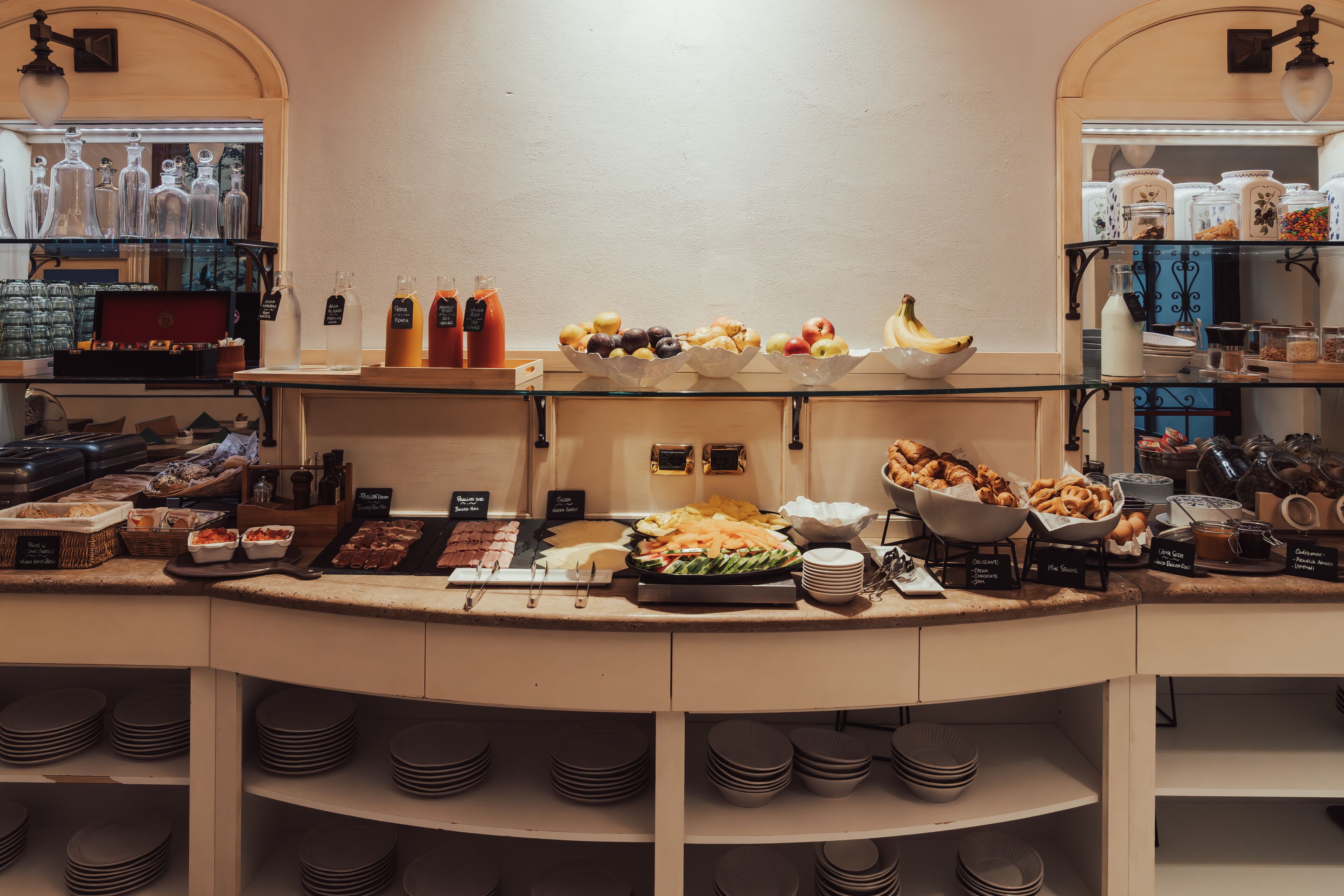 A buffet setup with various food items and condiments.