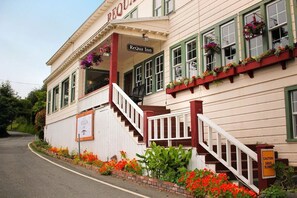 A building with a sign reading 'ReQua Inn' and a staircase leading to the entrance. - The Historic Requa Inn  (Klamath)