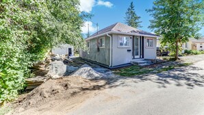 A small, single-story house with a sloped roof, a front porch, and a visible garage door. - 3 bedroom house near scugog lake (Caesarea)