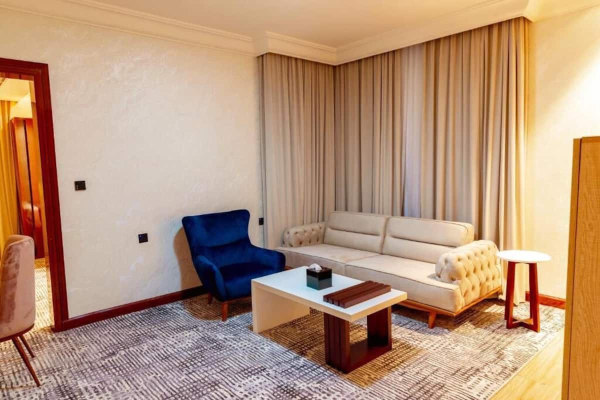Deluxe Apartment | Living area | 53-inch flat-screen TV with digital channels
