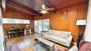 A cozy living room with a wooden ceiling, a sofa, a coffee table, and a dining area with chairs and a table. - MB Gem 2 - 1.3Miles To Beach, Close To LAX & Park (Manhattan Beach)