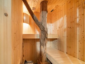 A wooden cabin interior with a wooden staircase, a bench, and a window. - Farmhouse in Staphorst With Sauna (Rouveen)