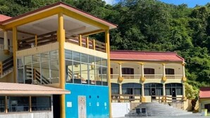 A hotel with a swimming pool, a covered area, and a building with a red roof. - West Palm Hotel (Chaguaramas)
