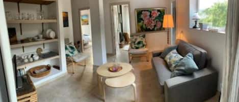 Relax in this inviting open-plan living space featuring a comfortable seating area, dining area, and kitchen.