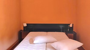 A narrow room with a bed, two bedside tables, and a headboard. - Beautiful Apartment in Vecchia With Pool (Briatico)