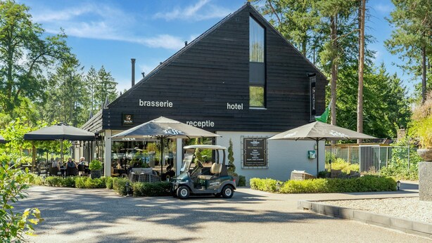 A building labeled 'brasserie' and 'hotel' with outdoor seating and a golf cart. - Holiday Home in Gelderland Near Den Bramel (Lochem)