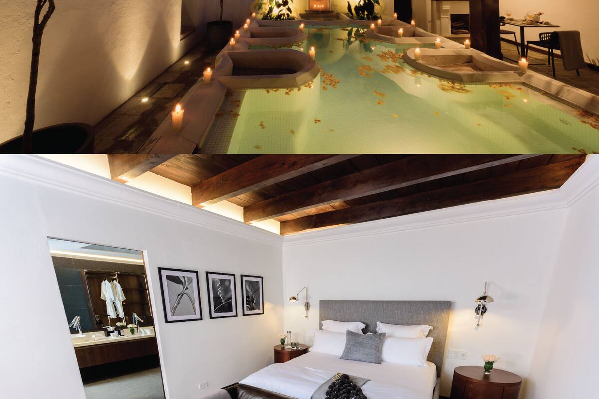 A luxurious hotel room with a large bed, a bathroom with a mirror and sink, and a pool area with candles.