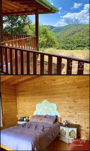 Overlooking the mountains, this cabin features a bedroom with a bed, nightstand, and decorative headboard, plus a balcony with a railing and awning.