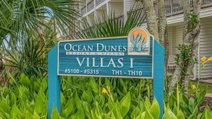 A sign for OceanDunes Resort & Villas, Villas I, with room numbers #5100 to #5315 and TH1 to TH10.