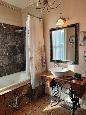 A bathroom with a bathtub, a sink, a mirror, and a shower curtain. - Buffalo Harmony House (Buffalo)