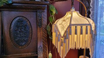 A wooden cabinet with a decorative floral panel and a hanging lamp with tassels.