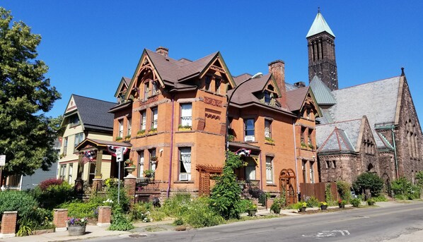 A historic building with a prominent tower and a large entrance. - Buffalo Harmony House (Buffalo)