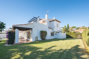 Enjoy a serene outdoor space with a covered patio and beautifully manicured lawn.