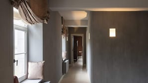 A hallway with a bench, a radiator, and a door leading to another room. - Stately 16-person Manor Farm in South Limburg (Schimmert)