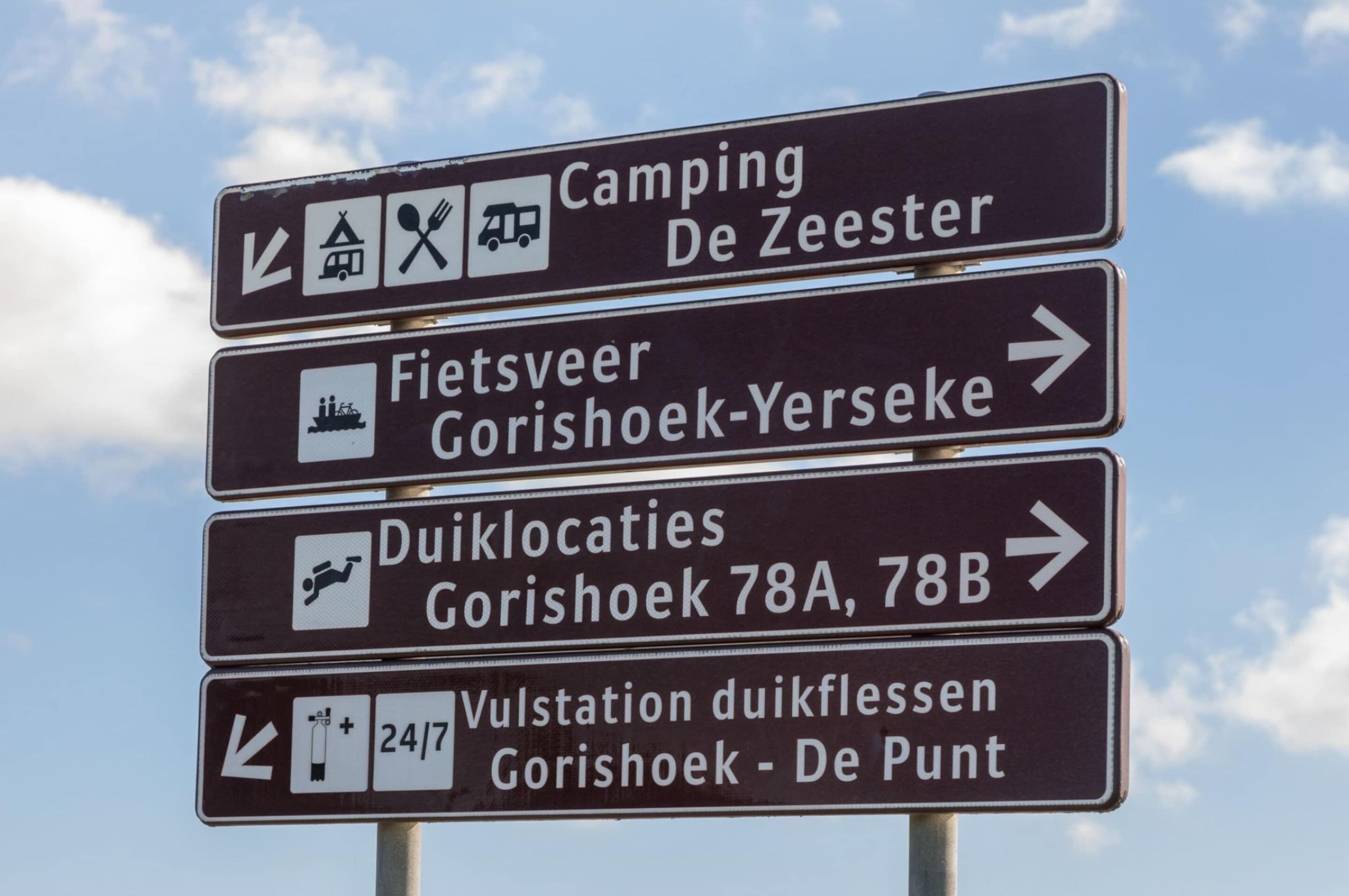A directional sign with multiple arrows indicating various destinations.