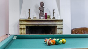 A billiards table with a row of billiard balls in front of a fireplace with a statue. - Lavish Sicilian Villa With Pool (Ficarra)