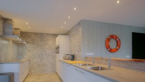 A modern kitchen with a patterned backsplash, a stainless steel sink, and a toaster. - Attractive Holiday Home in Callantsoog With Fenced Garden (Callantsoog)