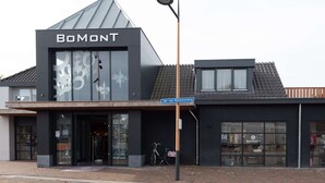 A building with a modern design, featuring a prominent 'BOMONT' sign on the facade. - Studio in Domburg Near Beach and Nature Reserve (Renesse)