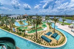 A resort with a large pool, a golf course, and a water slide. - New! Themed 5BR w/Pool-Storey Lake! (Kissimmee)