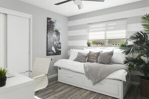 A modern bedroom with a bed, a desk, and a chair. There is a window with blinds, a ceiling fan, and a wall-mounted artwork. - POOL▪️FIREPITS▪️CORNHOLE▪️1/3 ACRE LOT (Phoenix)