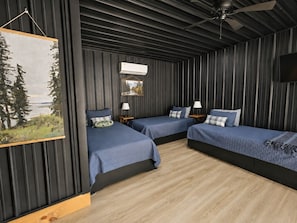 Un dormitorio con dos camas, un ventilador de techo y un cuadro en la pared.