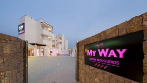 A modern building with a sign for 'MY WAY LUXURY IBIZA STUDIOS' and a stone wall entrance. - My Way Luxury Ibiza (Sant Josep de sa Talaia)