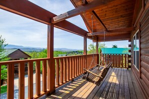 A wooden deck with a swing, overlooking a mountainous landscape. - Cozy Mountain Cabin I A++ Views & Amenities (Sevierville)