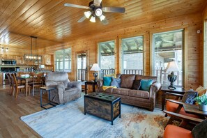 A wooden cabin interior with a dining area, living room, and kitchen. - Cozy Mountain Cabin I A++ Views & Amenities (Sevierville)