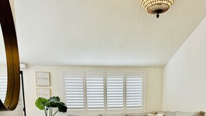 Una sala de estar con un sofá seccional, una mesa de centro y una planta en maceta.