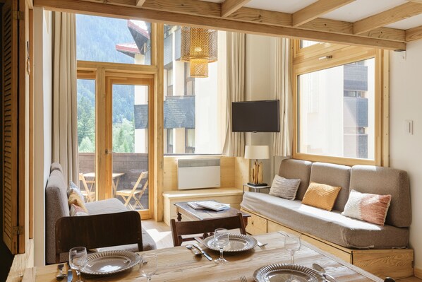 Enjoy a meal at the dining table, relax on the sofa, or watch TV in this comfortable room with a view.