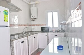 Fridge, microwave, cookware/dishes/utensils