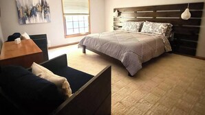 A bedroom with a bed, a desk, and a chair. - 15 Fisher's Paradise on Lake Saluda w Boat Ramp (Greenville)
