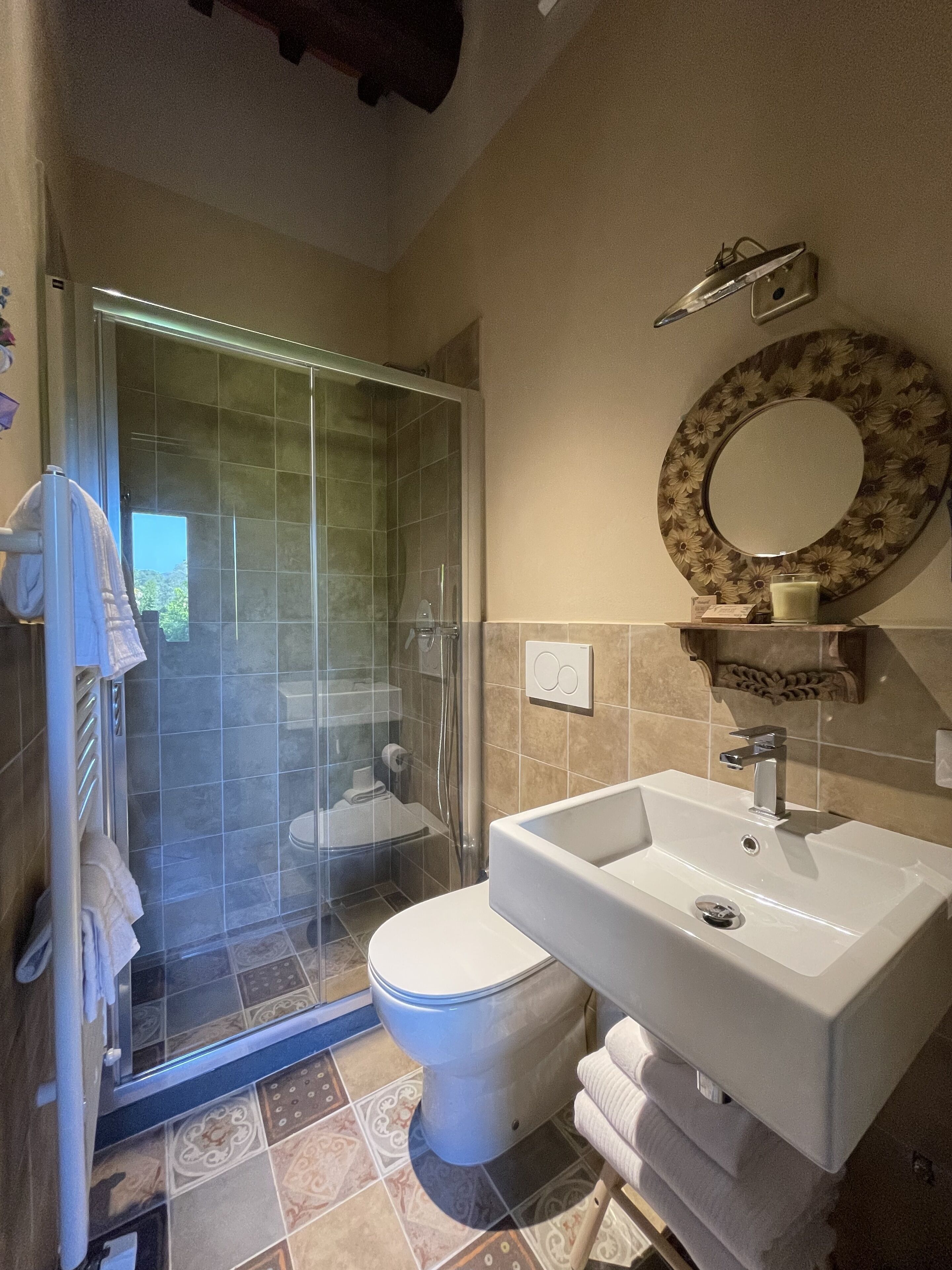 A bathroom with a shower, toilet, and sink.