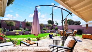 A patio area with outdoor furniture, a swing, and a garden. - 20% Disc-Modern-King Bed, Jacuzzi, Fire Pit, BBQ+ (Los Angeles)