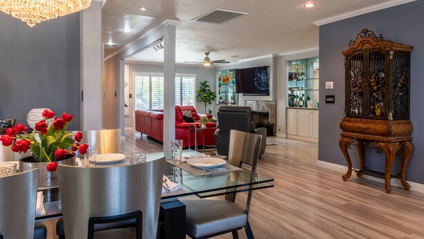 A modern living room with a dining area, a red sofa, and a vintage cabinet. - 20% Disc-Modern-King Bed, Jacuzzi, Fire Pit, BBQ+ (Los Angeles)