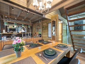 A wooden dining table set with plates, cutlery, and a potted plant. - Romantic Chalet Near Wilhelminadorp (Wilhelminadorp)