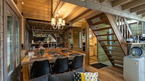 A cozy wooden interior with a dining area, staircase, and kitchen. - Romantic Chalet Near Wilhelminadorp (Wilhelminadorp)