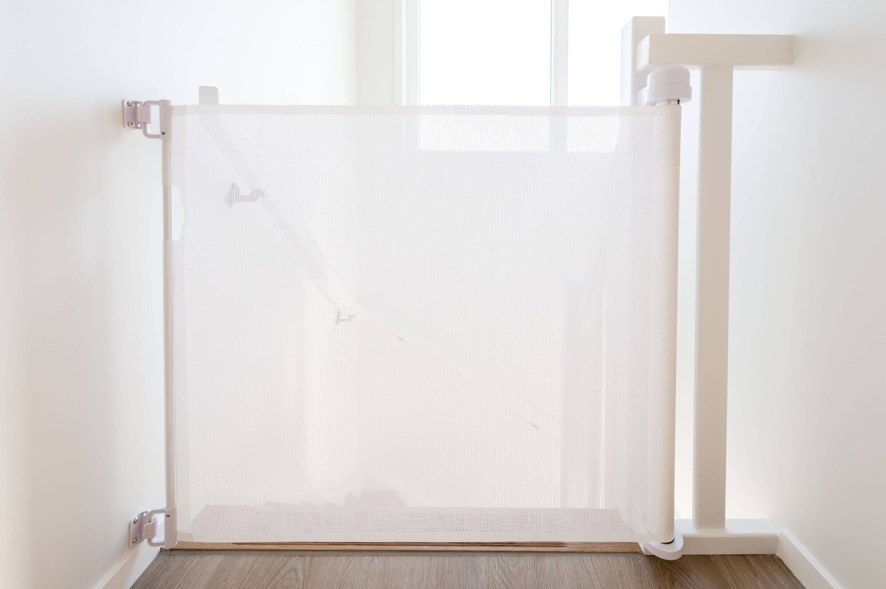 A white room with a white door, a white wall, and a white floor.