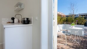 A modern kitchen with a built-in oven, a coffee maker, and a kettle. - Holiday Home in Oostkapelle Near the Beach (Oostkapelle)
