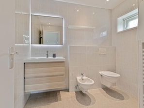 A modern bathroom with a vanity, bidet, and toilet. - Amazing Holiday Home in Kamperland With Sauna (Kamperland)
