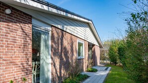 A modern brick house with large windows and a paved walkway. - House Near Veerse Meer and North Sea Beach (Kamperland)
