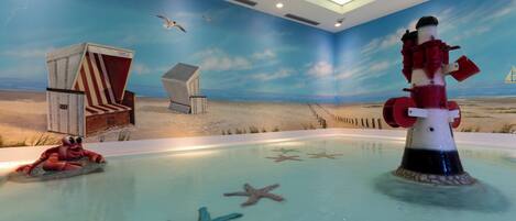 A pool with starfish and a lifeguard stand.